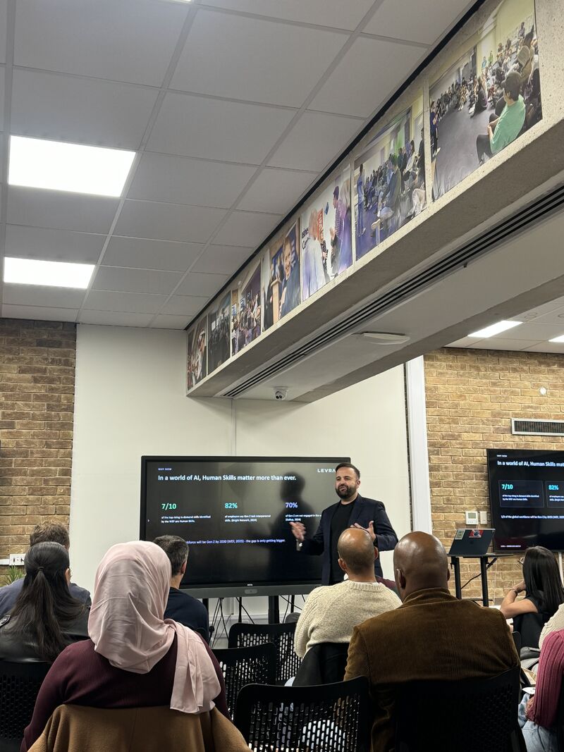 People sat in a room watching a talk